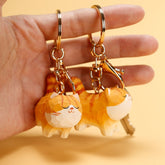 Two Chubby Orange Cat Keychains held in a hand, showcasing the keychains' details.
